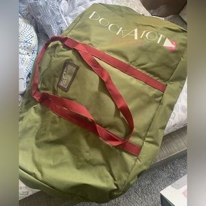 DOCKATOT travel case new never used color is olive green with burgundy straps